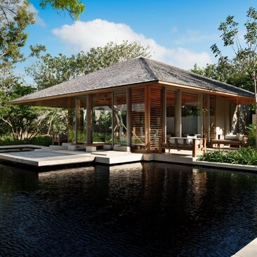 Four-bedroom villa bedroom exterior with wooden pavilion overlooking reflecting pool at Amanyara, Turks and Caicos.