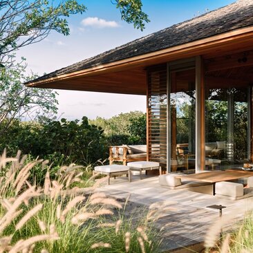 Four-bedroom villa bedroom terrace at Amanyara overlooking tropical gardens and ocean view.