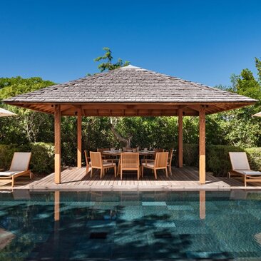 Four-bedroom beach villa with thatched pavilion overlooking the pool at Amanyara, Turks and Caicos.