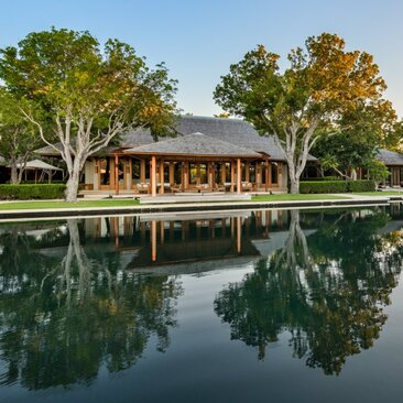 Five-bedroom Serenity Villa at Amanyara with wooden pavilion reflected in still water, Turks and Caicos.