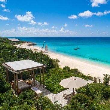 Beachfront sala with shaded pavilion overlooking turquoise waters at Amanyara, Turks and Caicos.