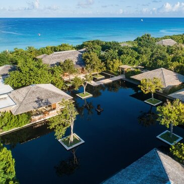Aerial view of Amanyara's six-bedroom beach sala villa with lagoon, lush grounds and private docks.