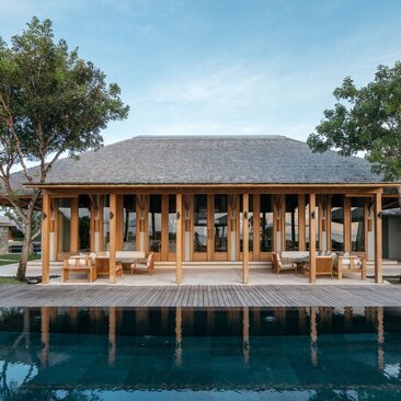 Amanyara resort pavilion with thatched roof overlooking turquoise waters, Turks and Caicos.