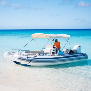 Snorkelling boat moored in shallow turquoise waters at Amanyara, Turks and Caicos.