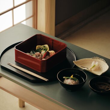 Tea service with seasonal kaiseki lunch at Aman Kyoto, featuring lacquered bowls and traditional Japanese tableware.