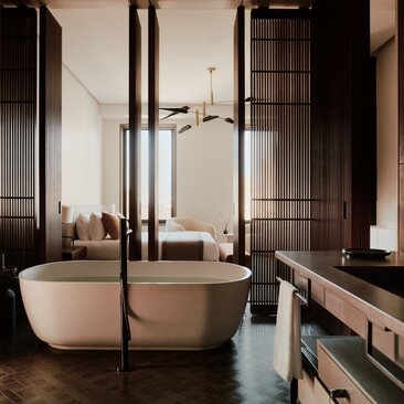 アマン ニューヨークの3ベッドルーム・ホームの浴室。黒い枠の大きな鏡の前に独立型バスタブがあり、洗練された照明が備わっています。