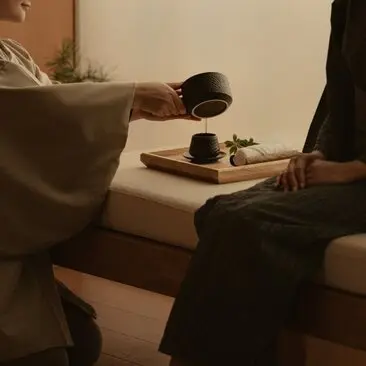 Therapist pouring water during a wellness treatment at Aman Tokyo hotel spa.