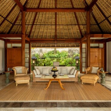 Living area of a one-bedroom villa at Amandari, Indonesia, with wooden furnishings and garden views.