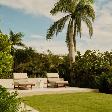 Casita Hill accommodation at Amanera resort with sunloungers on manicured lawn and palm trees, Dominican Republic.