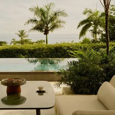 Casita pool at Amanera resort in Dominican Republic, framed by tropical palms and lush gardens.