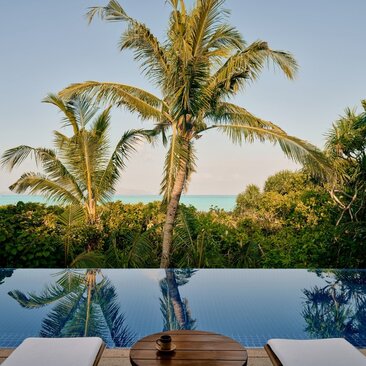 Grand Beach Pool Casita terrace at Amanpulo with infinity pool overlooking tropical palms and Philippine waters.