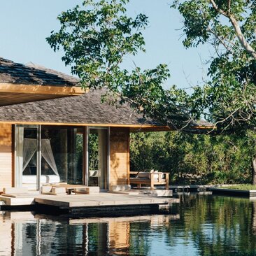 Four-bedroom beach villa at Amanyara with wooden sala overlooking a lagoon pool.