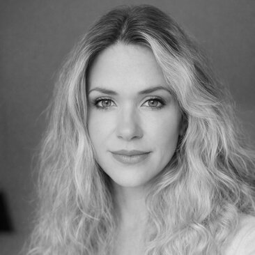 Black and white portrait photograph of a woman with long wavy hair at Amanyara.