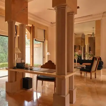 Garden Haveli Suite interior at Amanbagh with wooden columns, polished floors and open living spaces.