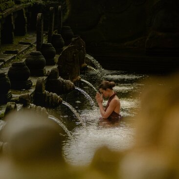 Ceremonial water blessing ritual during Melukat at Amandari, Bali.