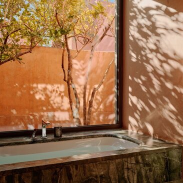 Deluxe Pavilion windowsill with view of Moroccan gardens at Amanjena resort.