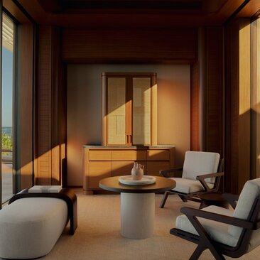 Beachfront casita living area at Amanvari, Mexico, with wooden interiors and modern furnishings bathed in golden sunlight.