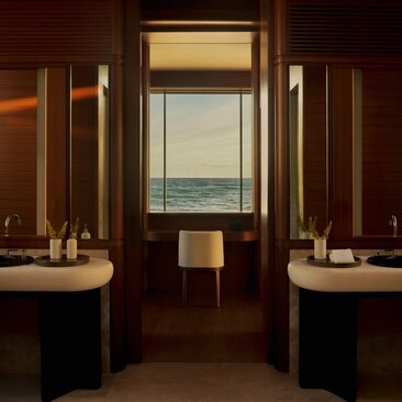 Beachfront casita bathroom with dual vanities and ocean view through transom window at Amanvari, Mexico.
