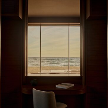 Beachfront casita at Amanvari with ocean view through window and desk seating.