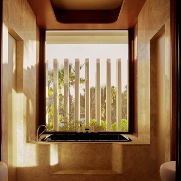 Wooden alcove with a window overlooking vertical garden slats at Amanvari, Mexico.
