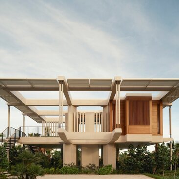 Elevated casita at Amanvari with wooden pergola and warm terracotta exterior, set against clear Mexican sky.