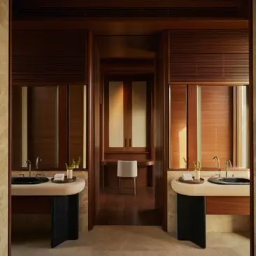 Elevated casita bathroom at Amanvari resort with dual vanities and warm wooden finishes.