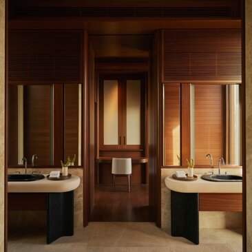Elevated casita bathroom at Amanvari with dual vanities and warm timber finishes.