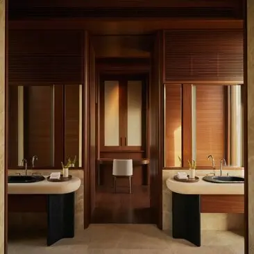 Casita bathroom with dual vanities and warm wood finishes at Amanvari resort, Mexico.