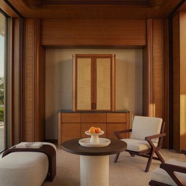 Amanvari Estuary Casita sitting area with wooden furnishings and minimalist décor.
