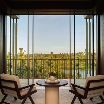 Horizon Casita at Amanvari with expansive views of Mexican countryside through floor-to-ceiling windows and seating area.