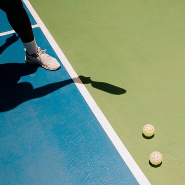 Pickleball court at Amanera with paddles and balls on play surface.