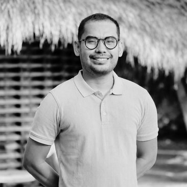 Imron, a staff member at Amandari in Bali, smiles at the camera in black and white portrait.