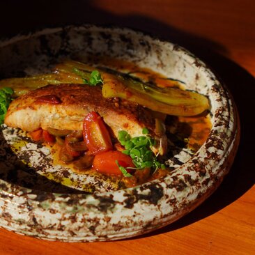 Wood-fired focaccia with roasted vegetables at Amandari's Mediterranean dining venue.