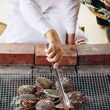 Diver's hands preparing tools at Amanemu resort.