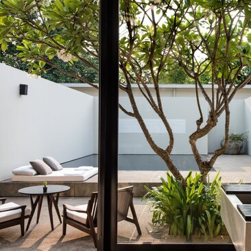 Pool Suite swimming pool at Amansara, Cambodia, with loungers and water view through trees.