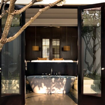 Pool Suite bathroom at Amansara, Cambodia, with freestanding soaked tub and natural light.