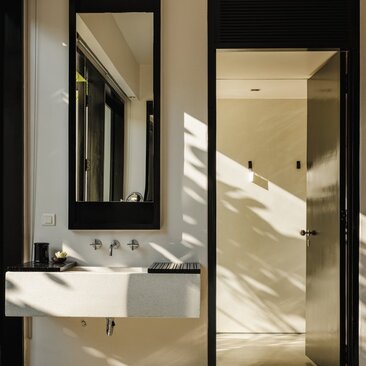 Bathroom with twin vanities and walk-in shower at Amansara, Cambodia.