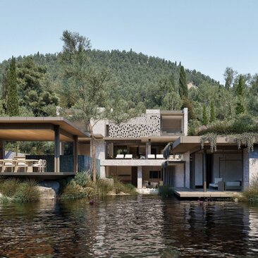 Waterfront pavilions at Amanruya with lagoon views, surrounded by forested hills.
