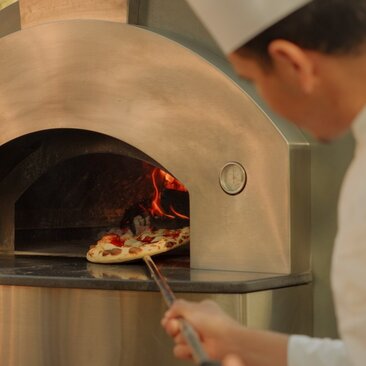 Pizza being prepared in a wood-fired oven at Amanvari, Morocco.