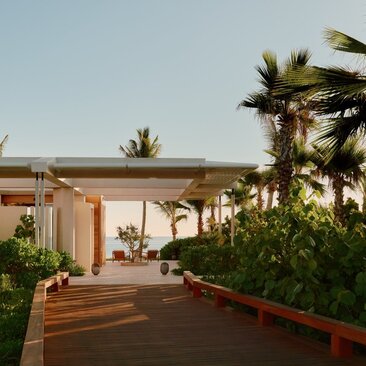 Beachfront casita with wooden deck, palm trees and ocean views at Amanvari, Mexico.