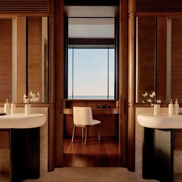 Beachfront casita bathroom with twin vanities, wooden cabinetry and ocean views at Amanvari, Mexico.