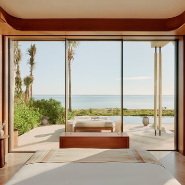 Beachfront casita interior at Amanvari with ocean views through floor-to-ceiling windows and wooden terrace.