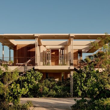 Amanvari casita with wooden pergola and desert vegetation at sunset in Mexico.