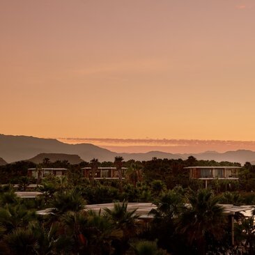 Amanvari nestled beneath golden hills at sunset, Mexico.