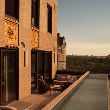 Three-bedroom home with pool at Aman New York, terrace at sunset.