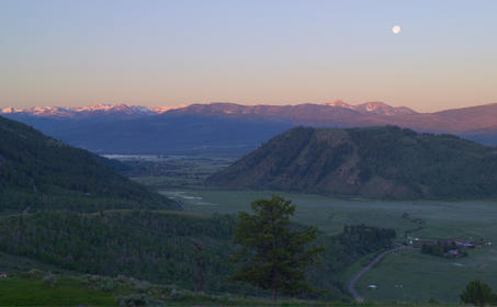 Moon rising over Jackson Hole valley at dusk from Amangani.