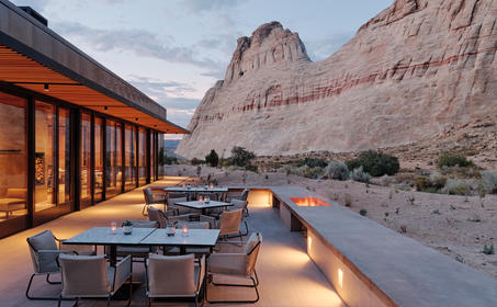 Sarika Dining pavilion at Amangiri with fire pit and desert mountain views at dusk.
