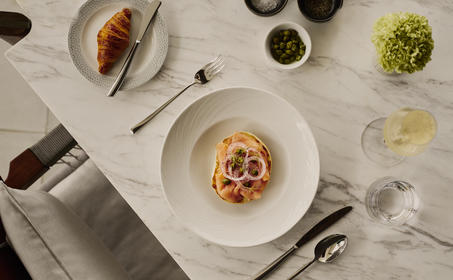 Amanera breakfast table setting with pasta dish and fresh ingredients in bowls.