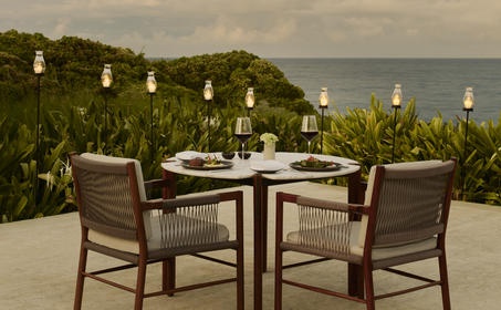 Private dining setup at Amanera with ocean views and candlelit tables.