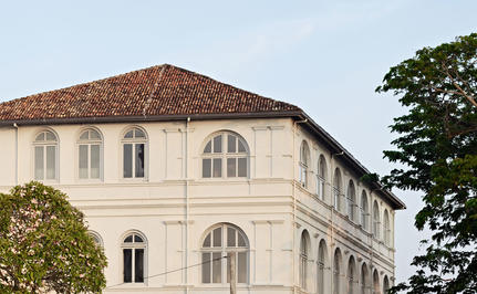 Cream-coloured colonial building at Amangalla with terracotta roof and arched windows.